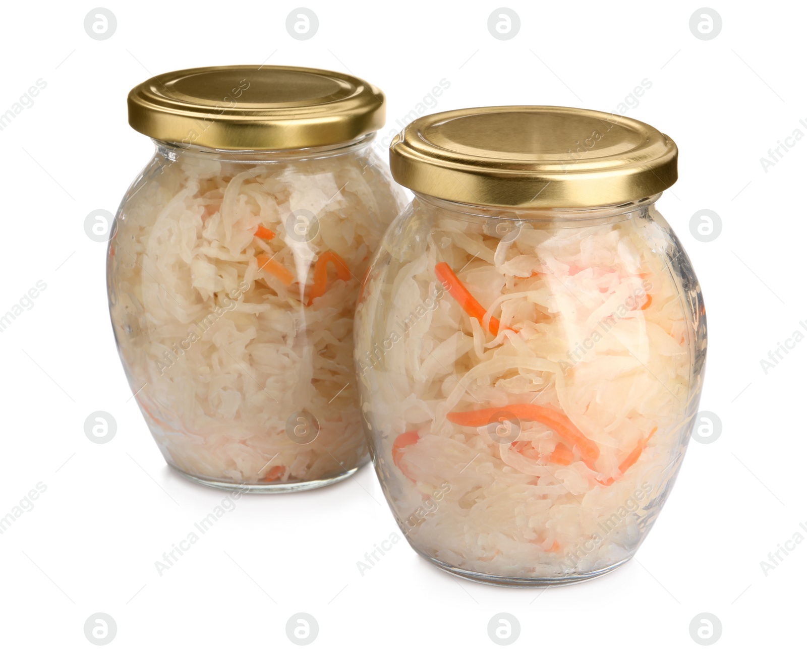 Photo of Glass jars of tasty fermented cabbage with carrot on white background