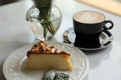 Photo of Tasty dessert and cup of fresh coffee on white table
