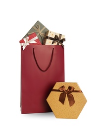 Photo of Paper shopping bag and gift boxes isolated on white