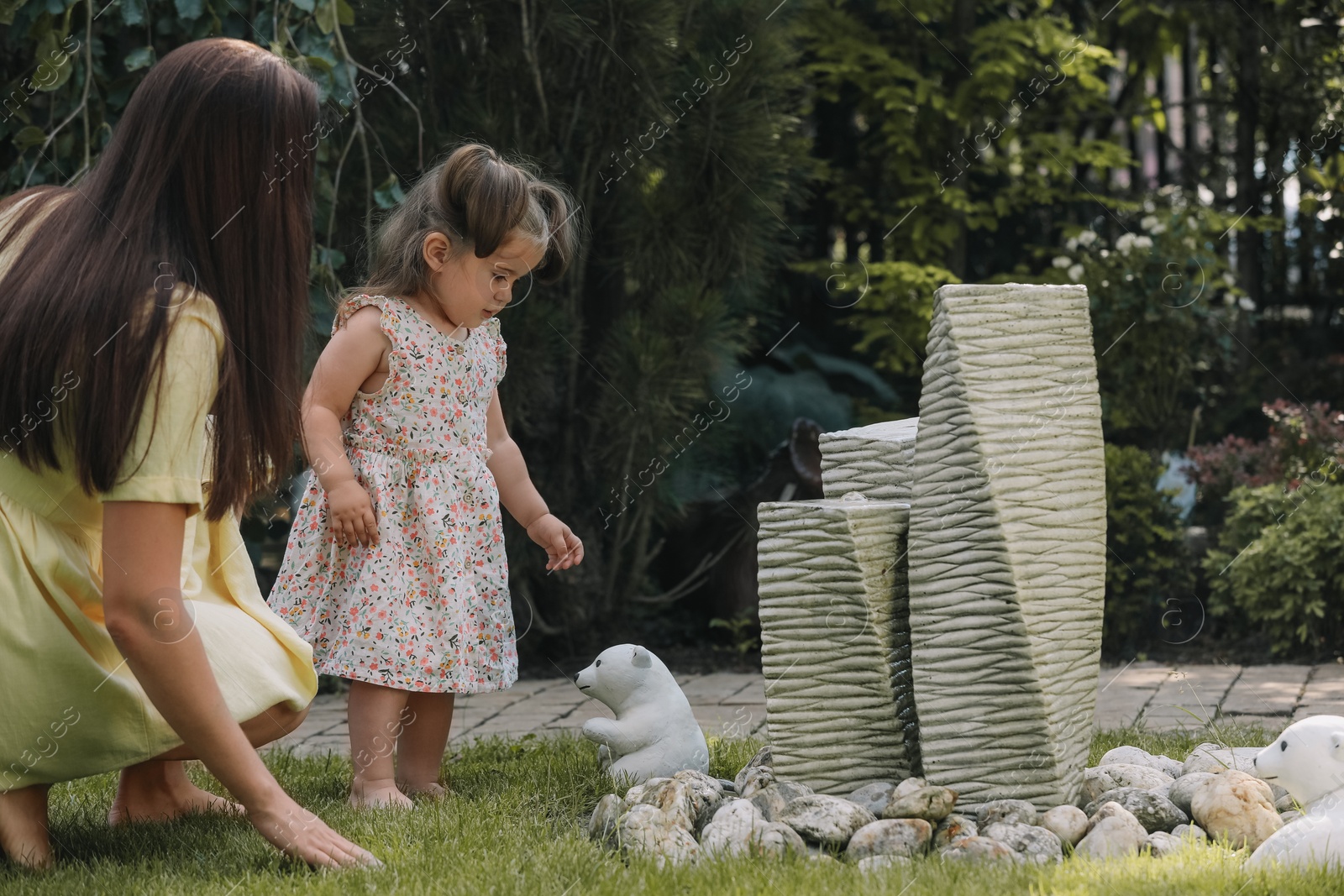 Photo of Mother with her cute daughter spending time together in park