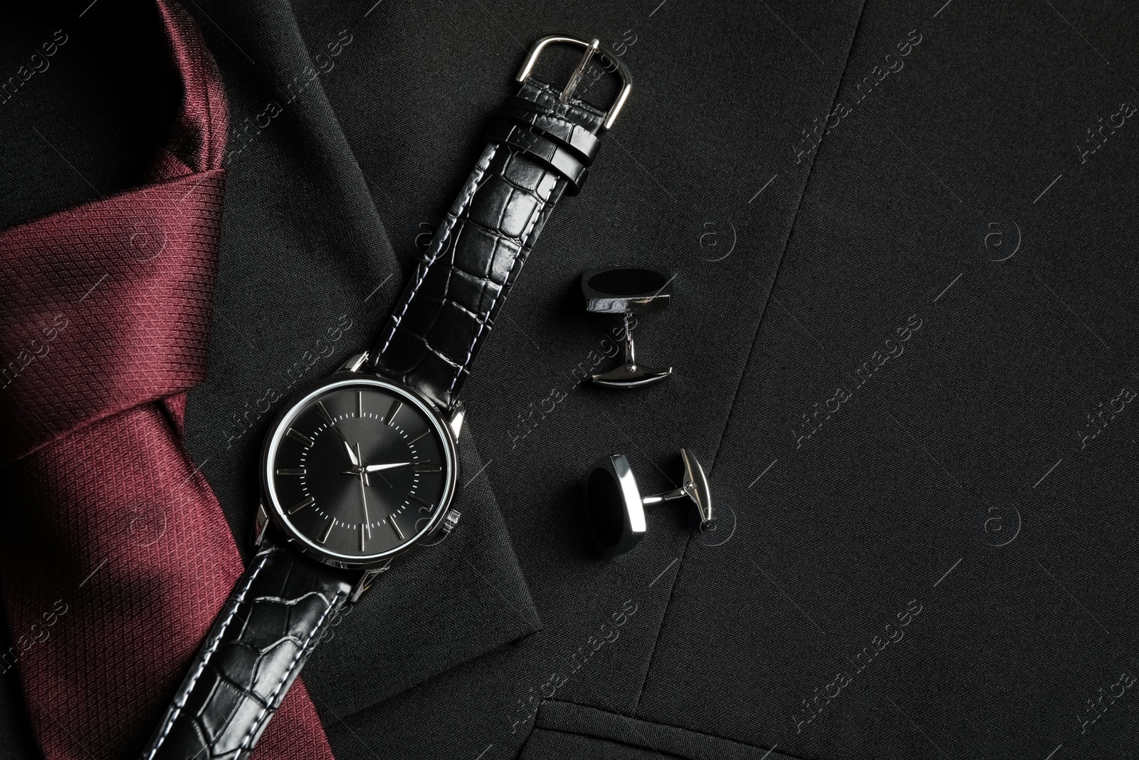 Photo of Flat lay composition with luxury wrist watch on black jacket