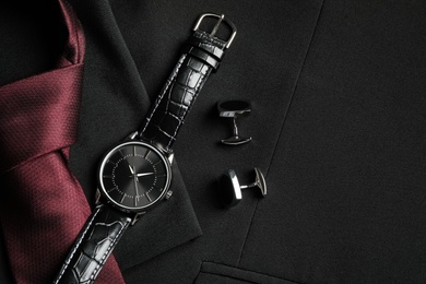 Photo of Flat lay composition with luxury wrist watch on black jacket