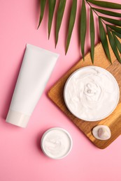 Flat lay composition with different cosmetic products on pink background
