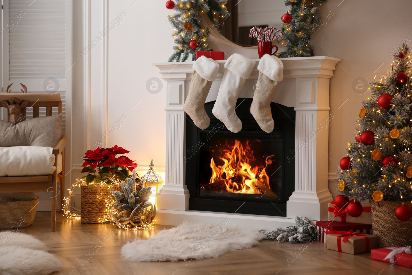 Photo of Fireplace with Christmas stockings in beautifully decorated living room