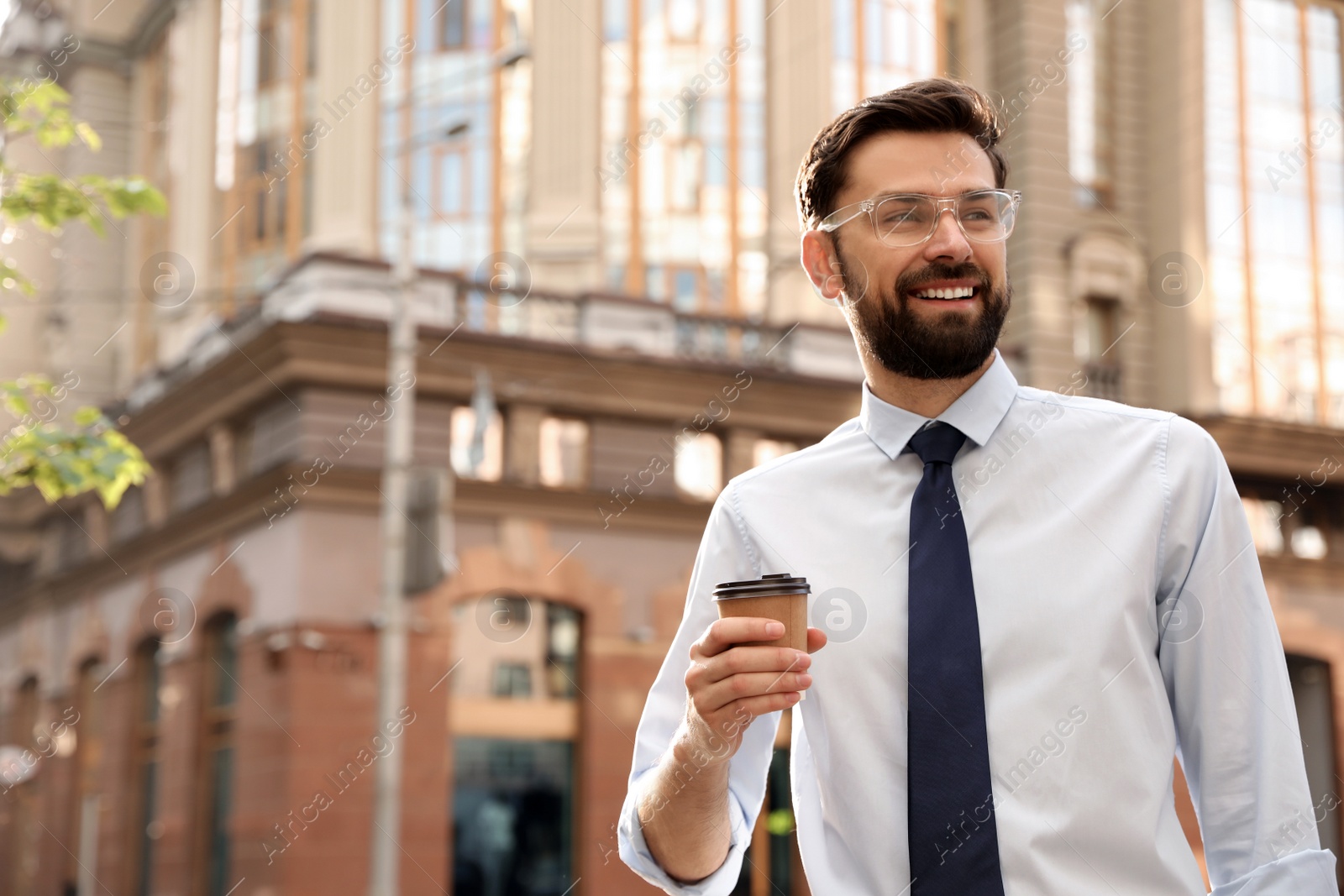 Photo of Handsome businessman in stylish outfit on city street