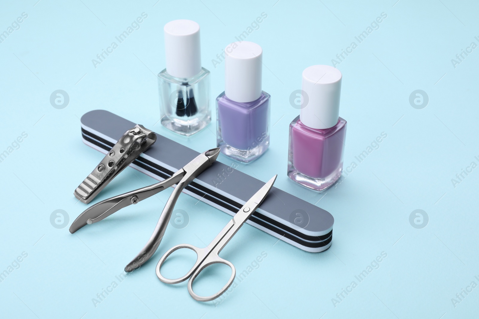 Photo of Set of pedicure tools on light blue background