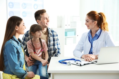 Family with child visiting doctor in hospital