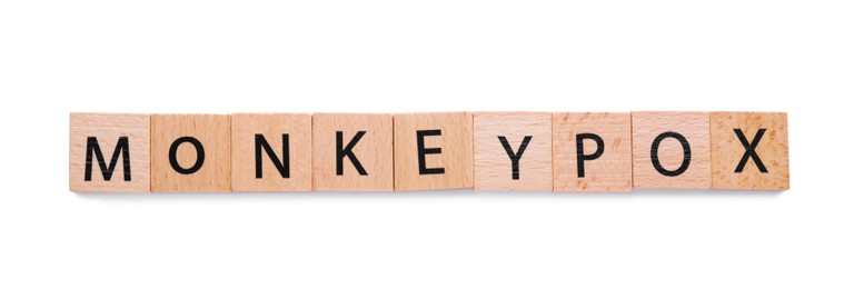Photo of Word Monkeypox made of wooden squares with letters on white background, top view