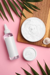 Flat lay composition with different cosmetic products on pink background