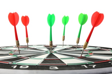 Photo of Dart board with color arrows hitting target, closeup