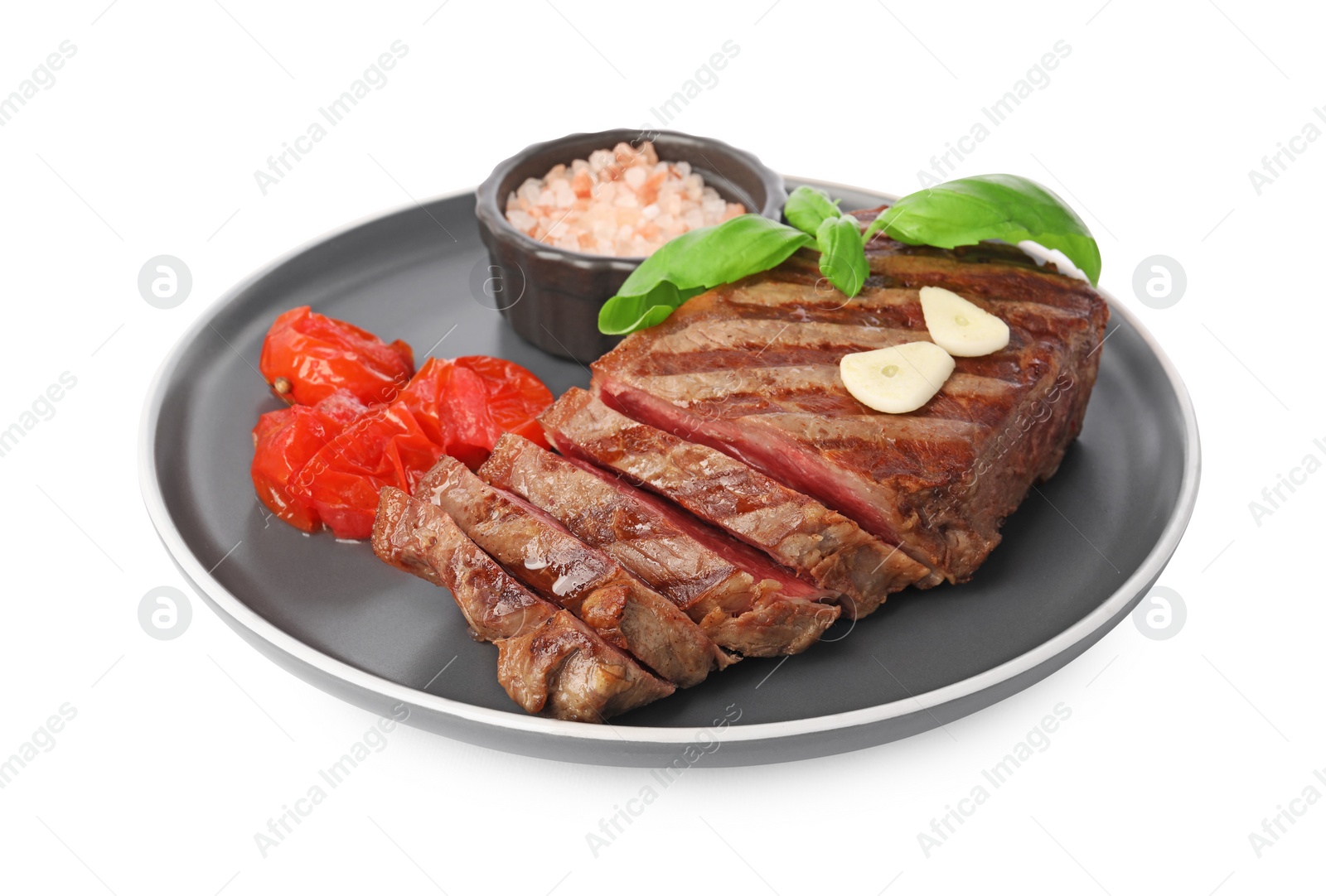 Photo of Delicious grilled beef steak with spices and tomatoes isolated on white