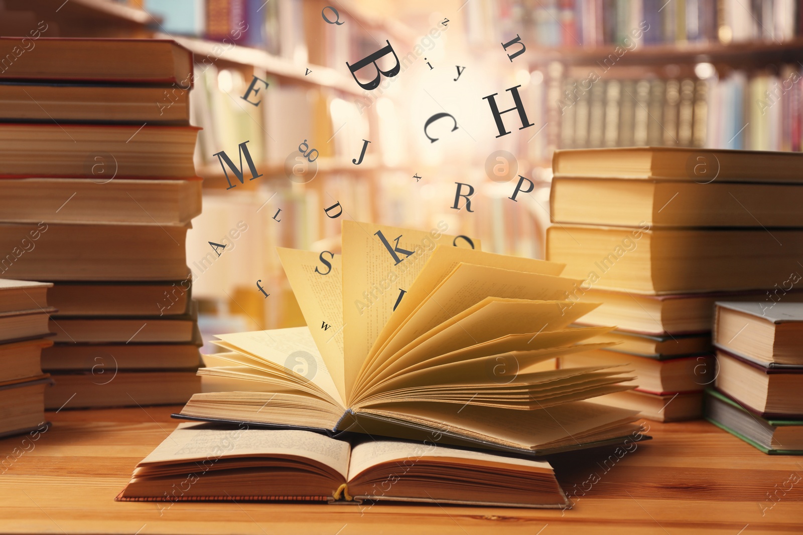 Image of Open book with letters flying out of it in library