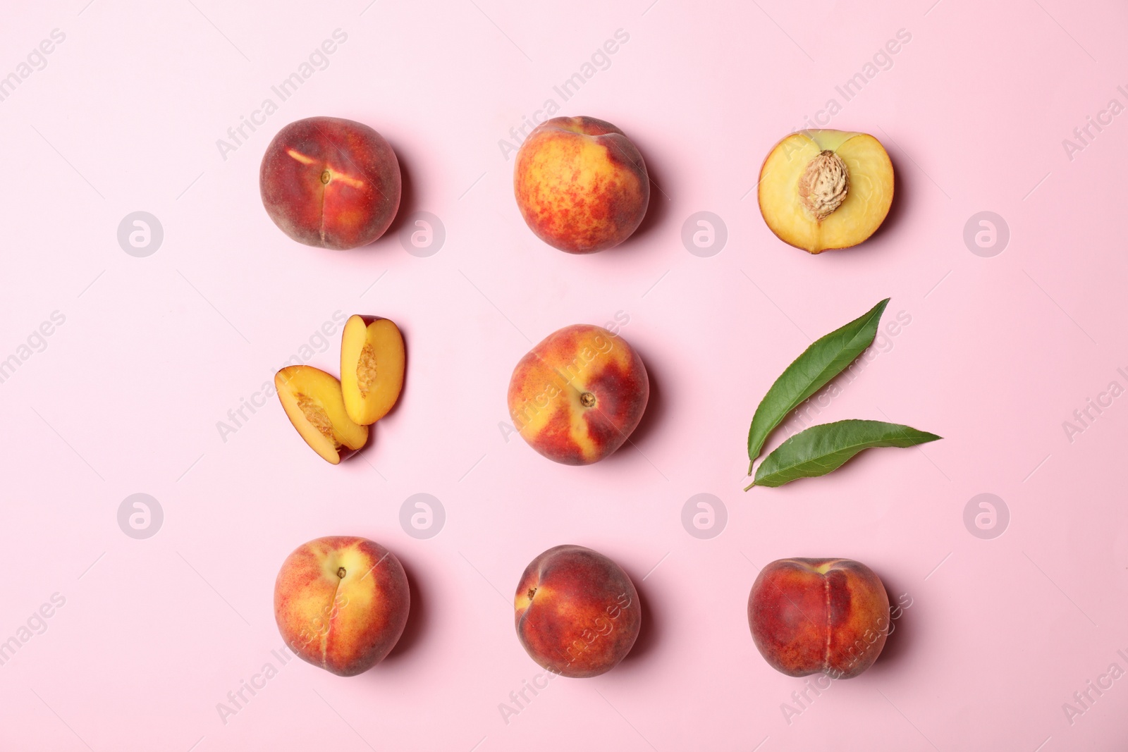 Photo of Flat lay composition with sweet juicy peaches on pink background