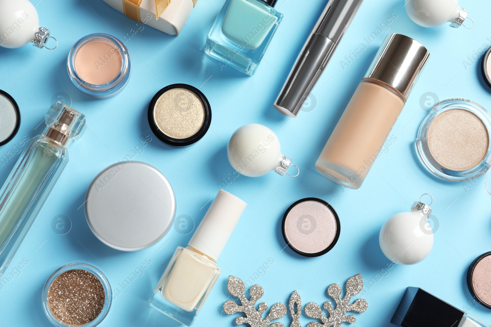 Photo of Flat lay composition with makeup products and Christmas decor on color background