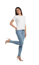 Photo of Happy woman wearing stylish light blue jeans and high heels shoes on white background