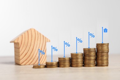 Mortgage rate. Stacked coins, arrows, percent signs and model of house