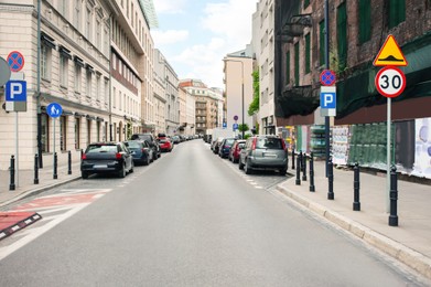 Photo of Beautiful view of city street with parked cars
