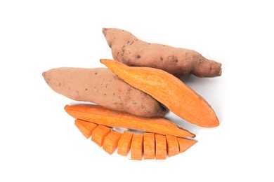 Photo of Cut and whole sweet potatoes on white background, top view