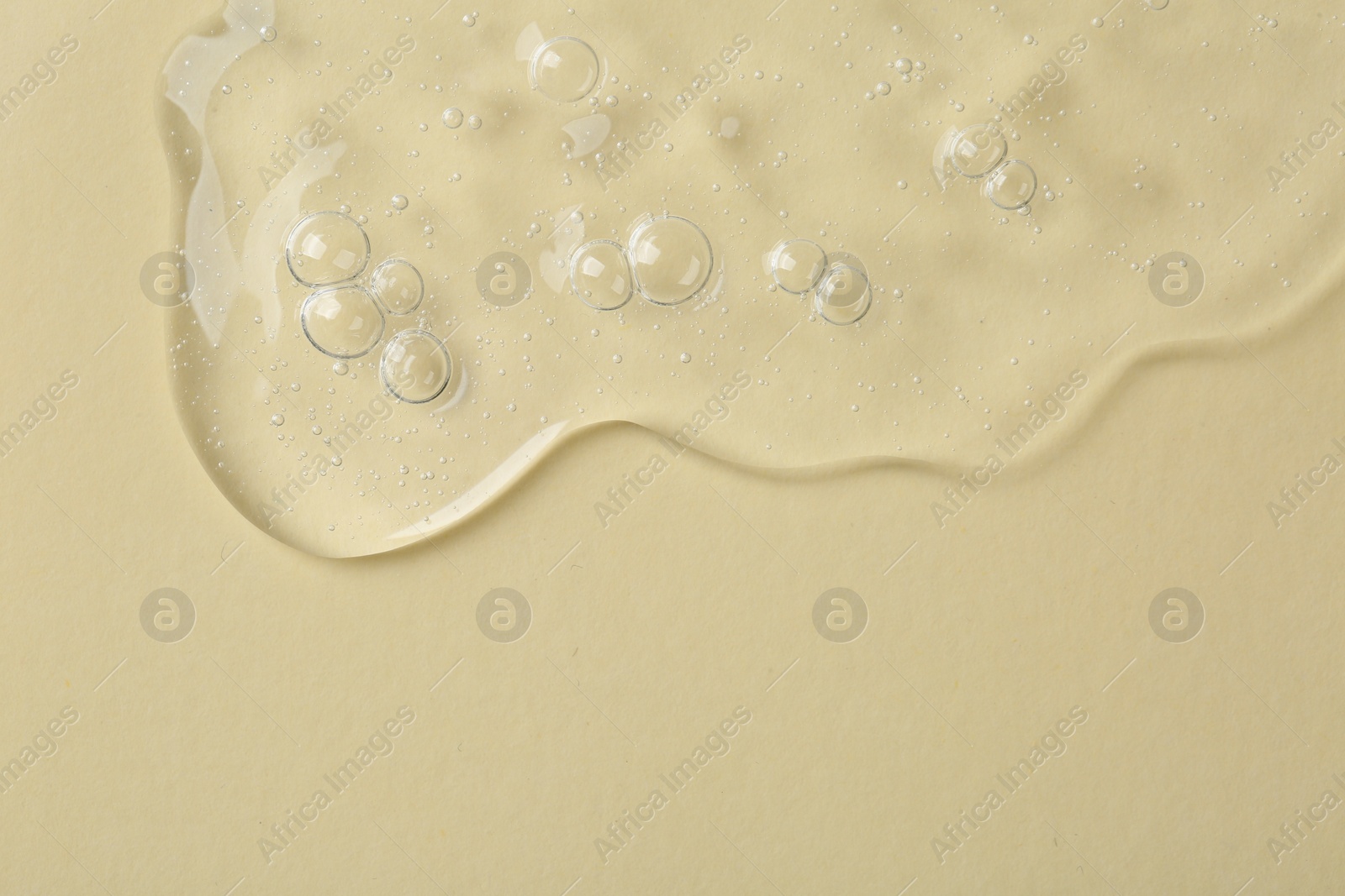 Photo of Cosmetic serum on beige background, top view. Space for text