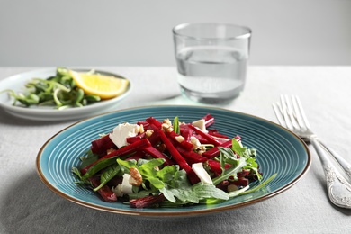 Plate with delicious beet salad served on table