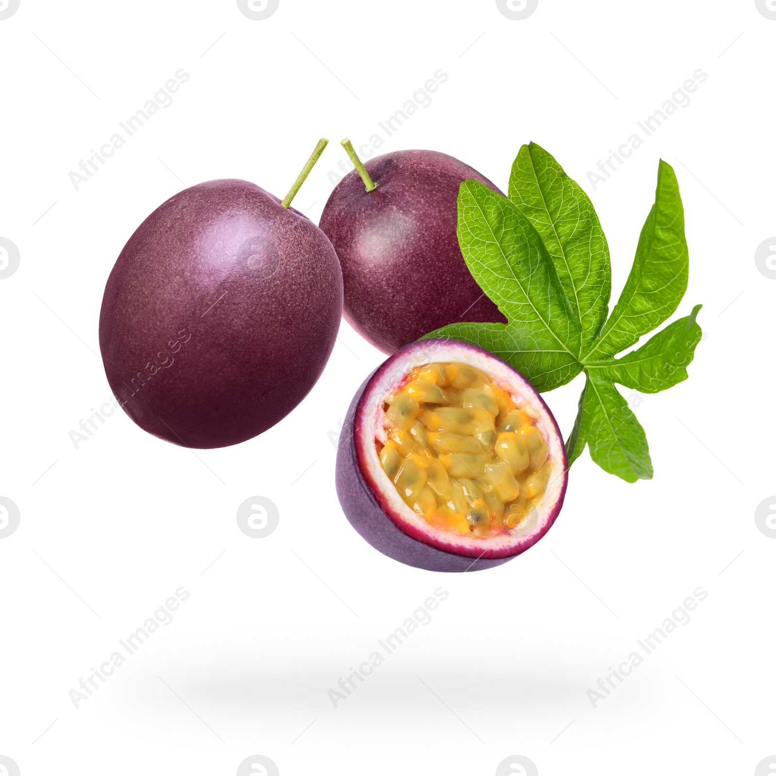 Image of Tasty passion fruits and passiflora leaf falling on white background
