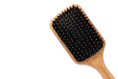 Photo of New wooden hair brush isolated on white, top view