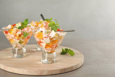 Photo of Delicious broken glass jelly dessert on grey table, space for text