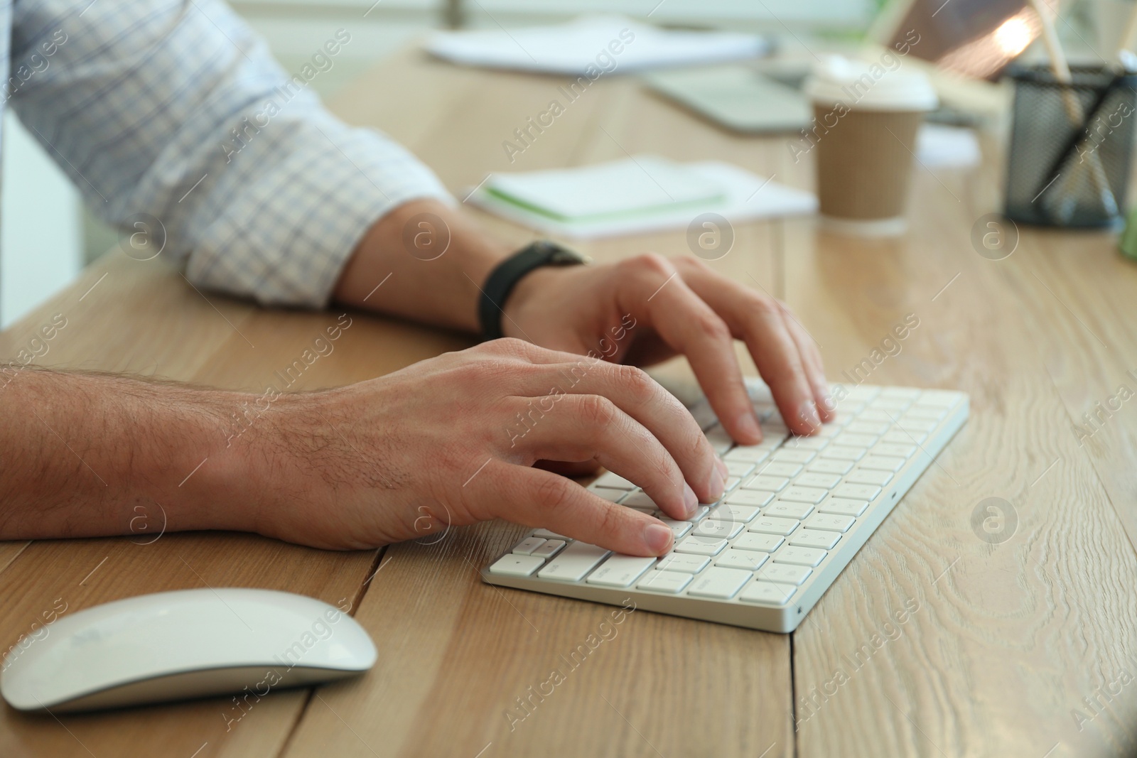 Photo of Freelancer working on computer at table indoors, closeup