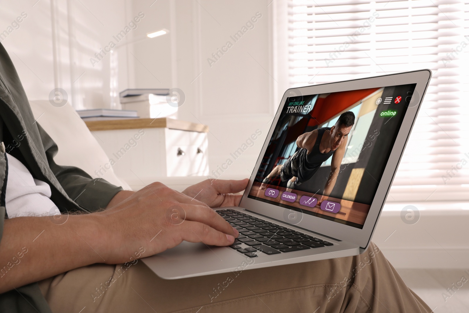 Image of Personal trainer online. Man viewing website via laptop at home, closeup