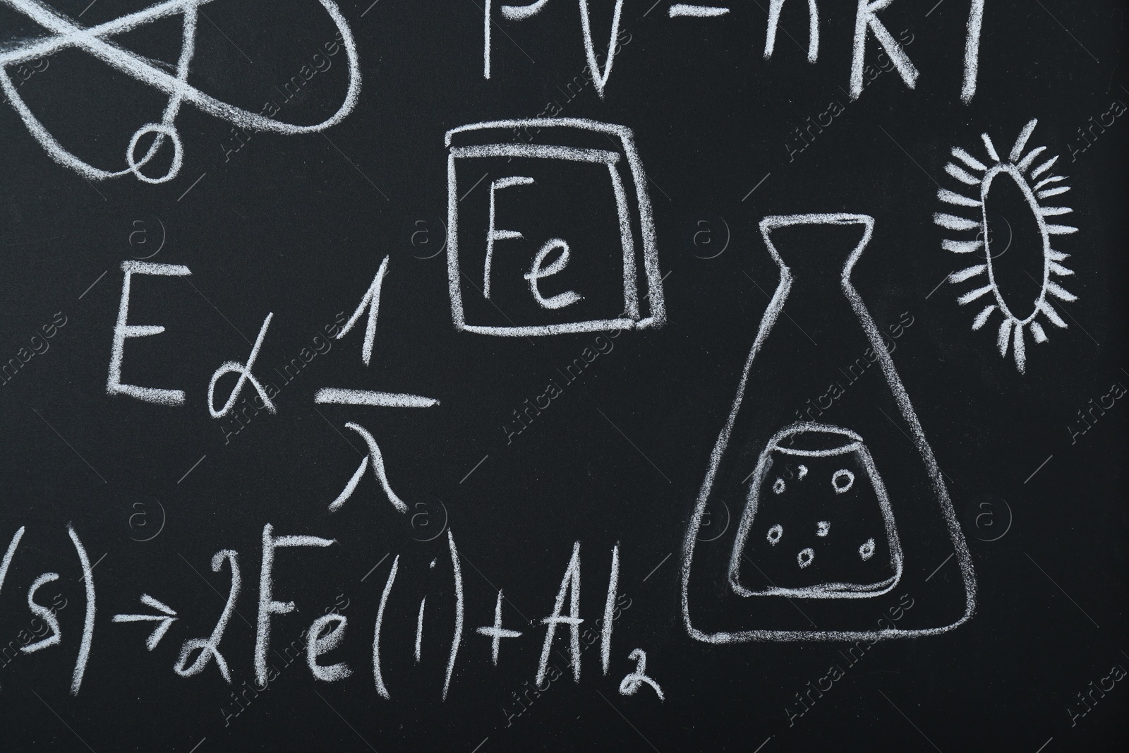 Photo of Different chemical formulas written with chalk on blackboard, closeup