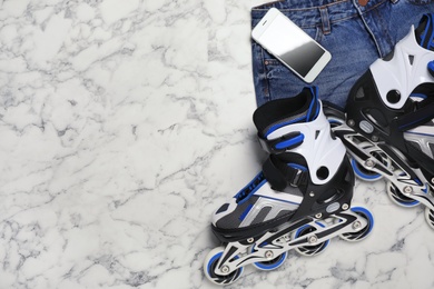 Photo of Flat lay composition with inline roller skates and space for text on marble background