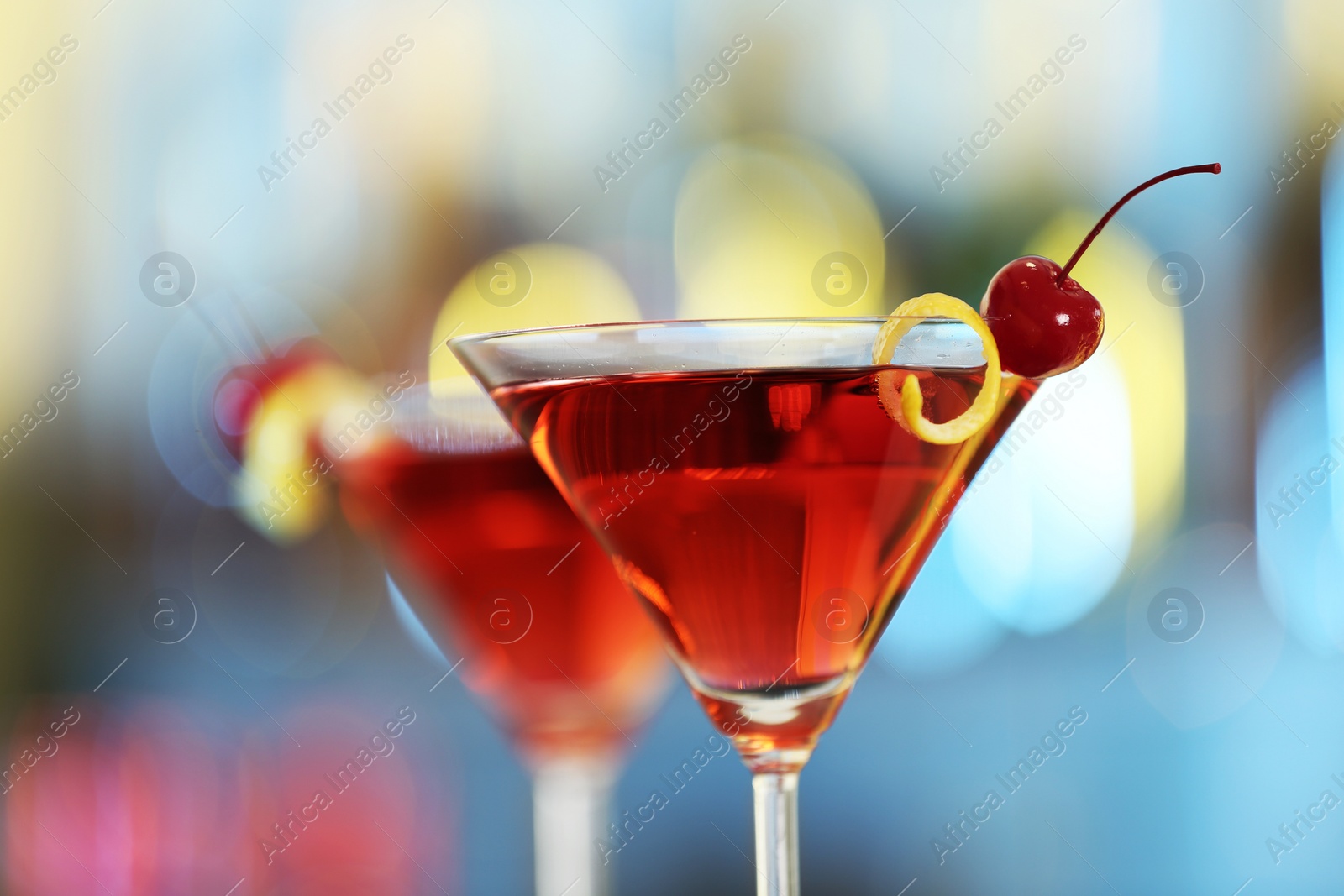 Photo of Glass of fresh alcoholic cocktail against blurred background