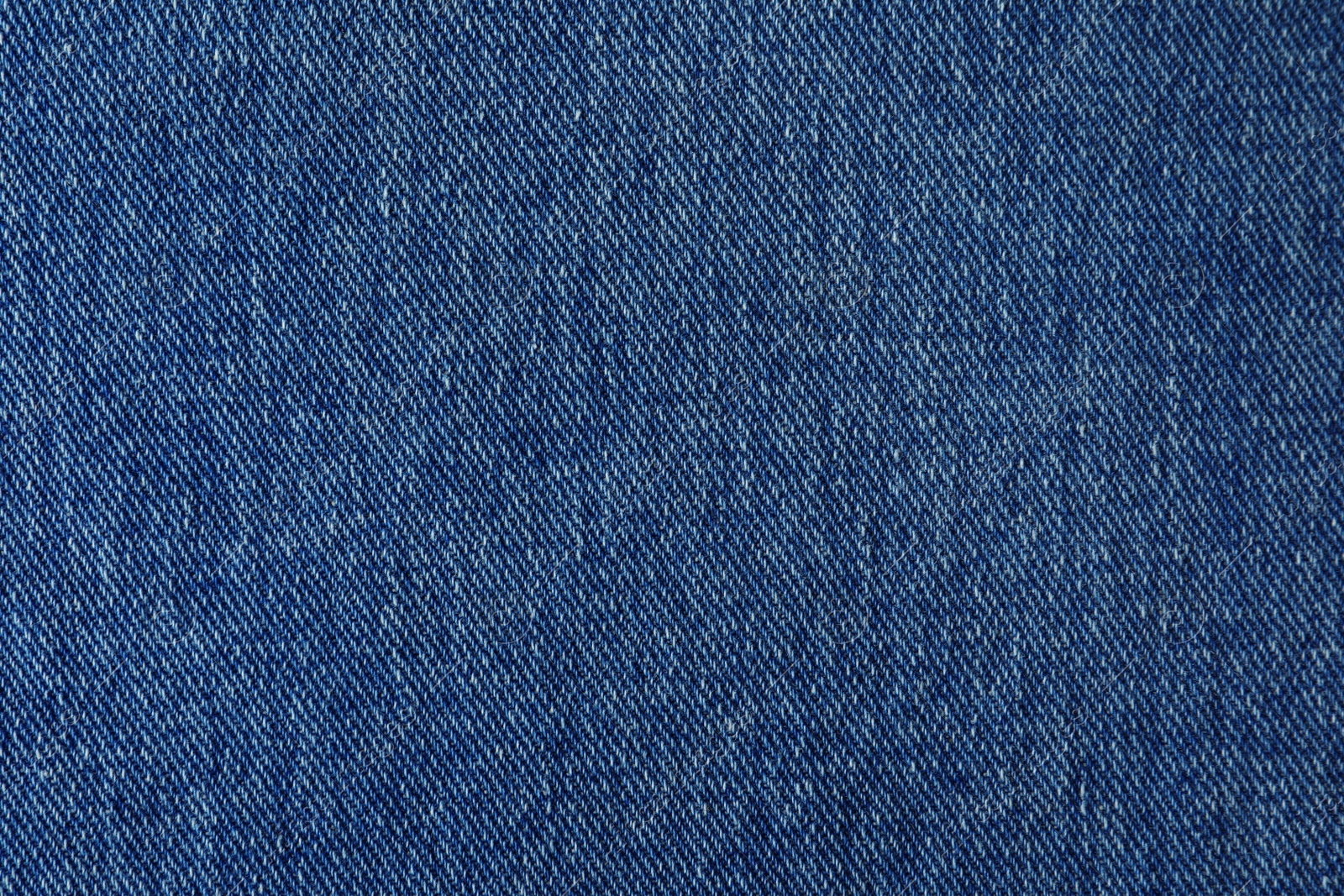 Photo of Texture of blue jeans as background, closeup