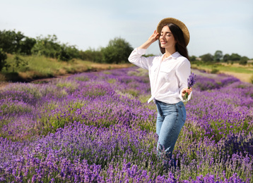 Photo of Young woman with lavender bouquet in field on summer day