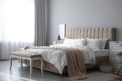 Photo of Comfortable bed with clean white linens indoors