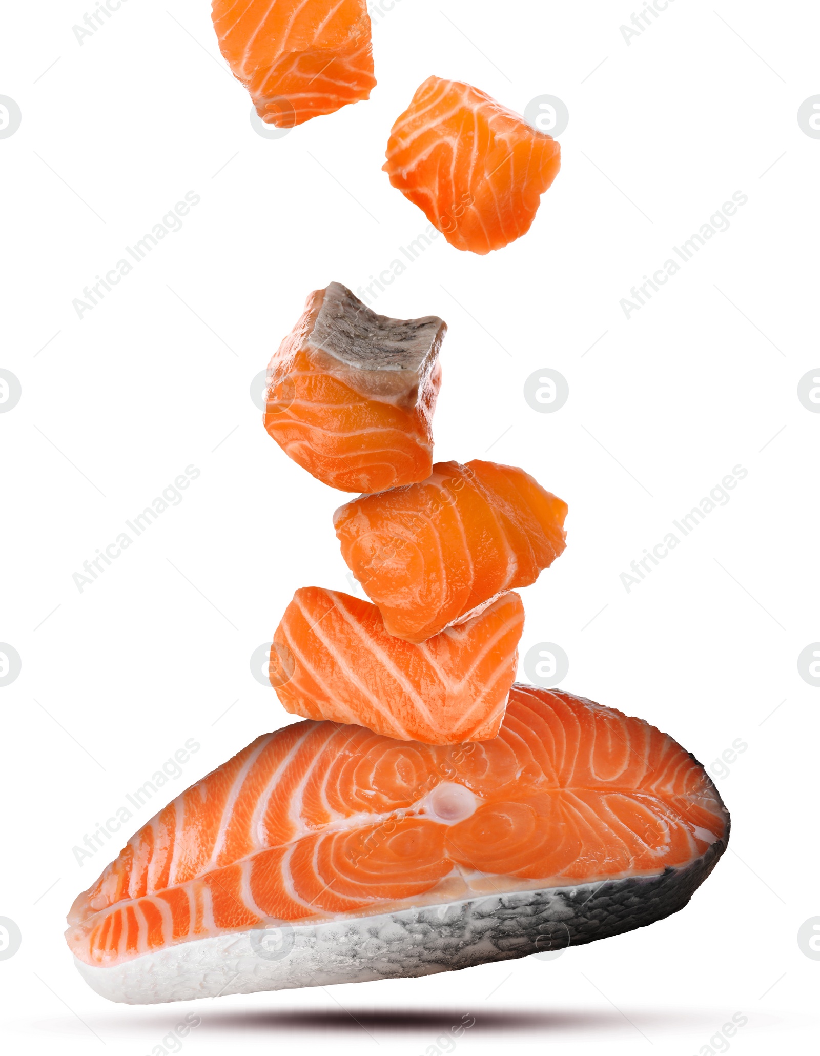 Image of Cut fresh salmon falling on white background