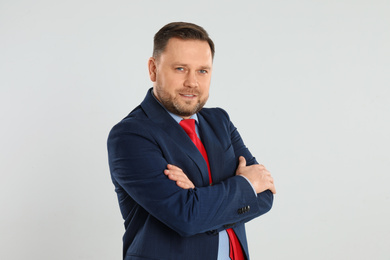 Portrait of happy mature man on light grey background