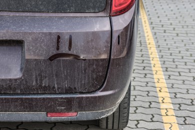 Sad smiley on dirty car outdoors, closeup