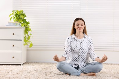 Photo of Woman meditating at home, space for text. Harmony and zen