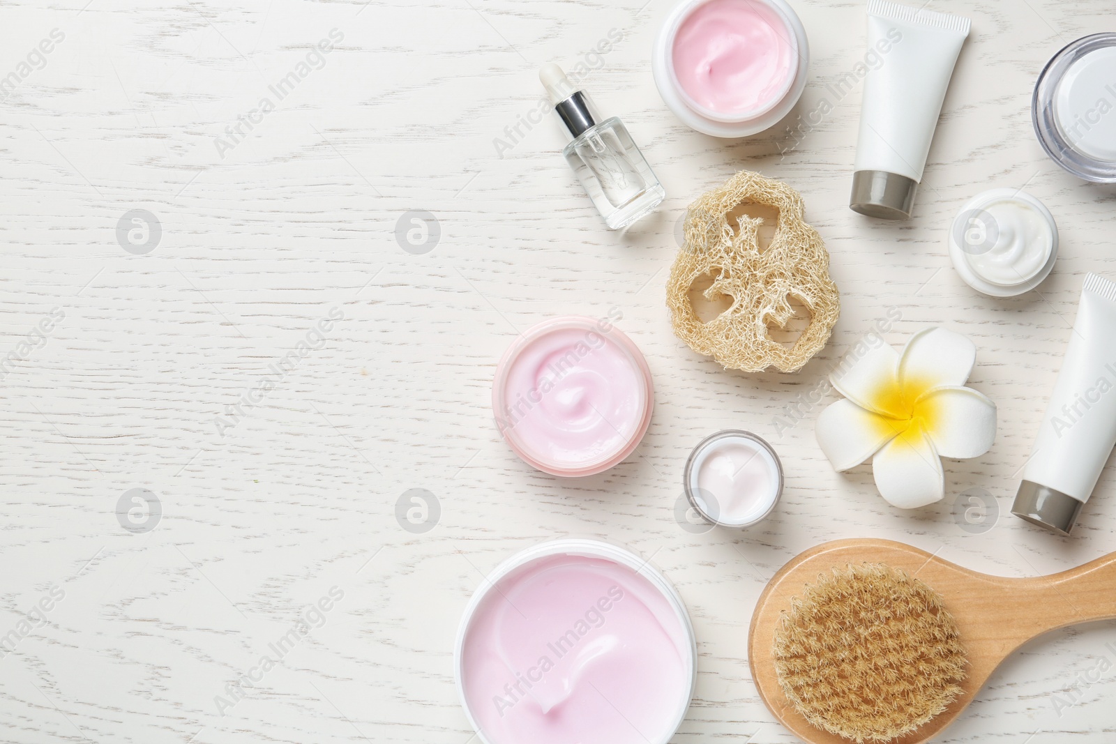 Photo of Flat lay composition with body care products and space for text on white wooden background