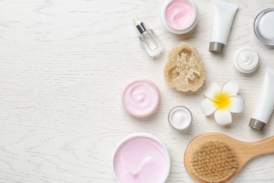 Photo of Flat lay composition with body care products and space for text on white wooden background