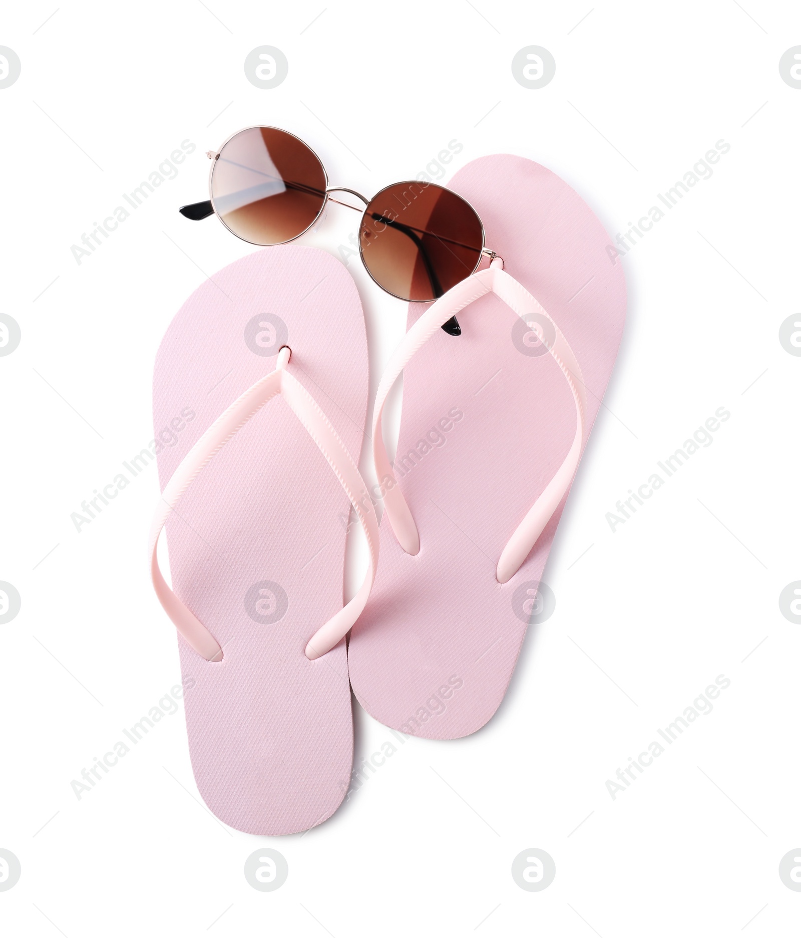 Photo of Flip flops and sunglasses on white background, top view. Beach objects