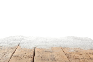 Photo of Artificial snow on wooden table against white background. Christmas decor