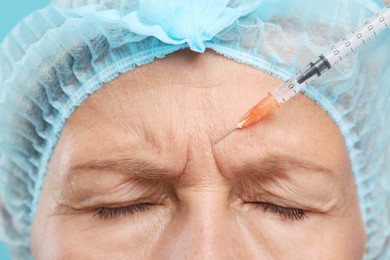Photo of Senior woman getting facial injection, closeup. Cosmetic surgery