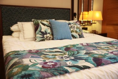 Photo of Large bed with pillows and linens in comfortable hotel room