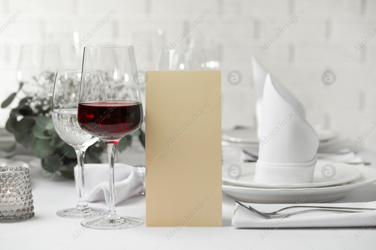 Photo of Glass of delicious wine and elegant table setting in restaurant