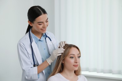 Young woman visiting trichologist in light clinic