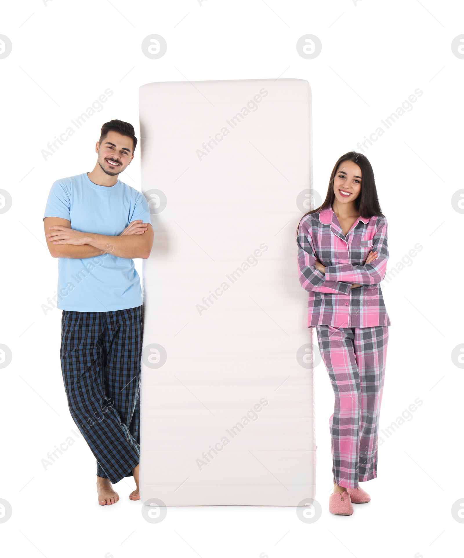 Photo of Young couple with comfortable mattress isolated on white