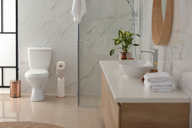 Interior of modern bathroom with toilet bowl