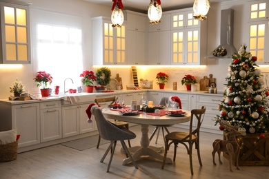 Photo of Stylish kitchen interior with beautiful Christmas decor